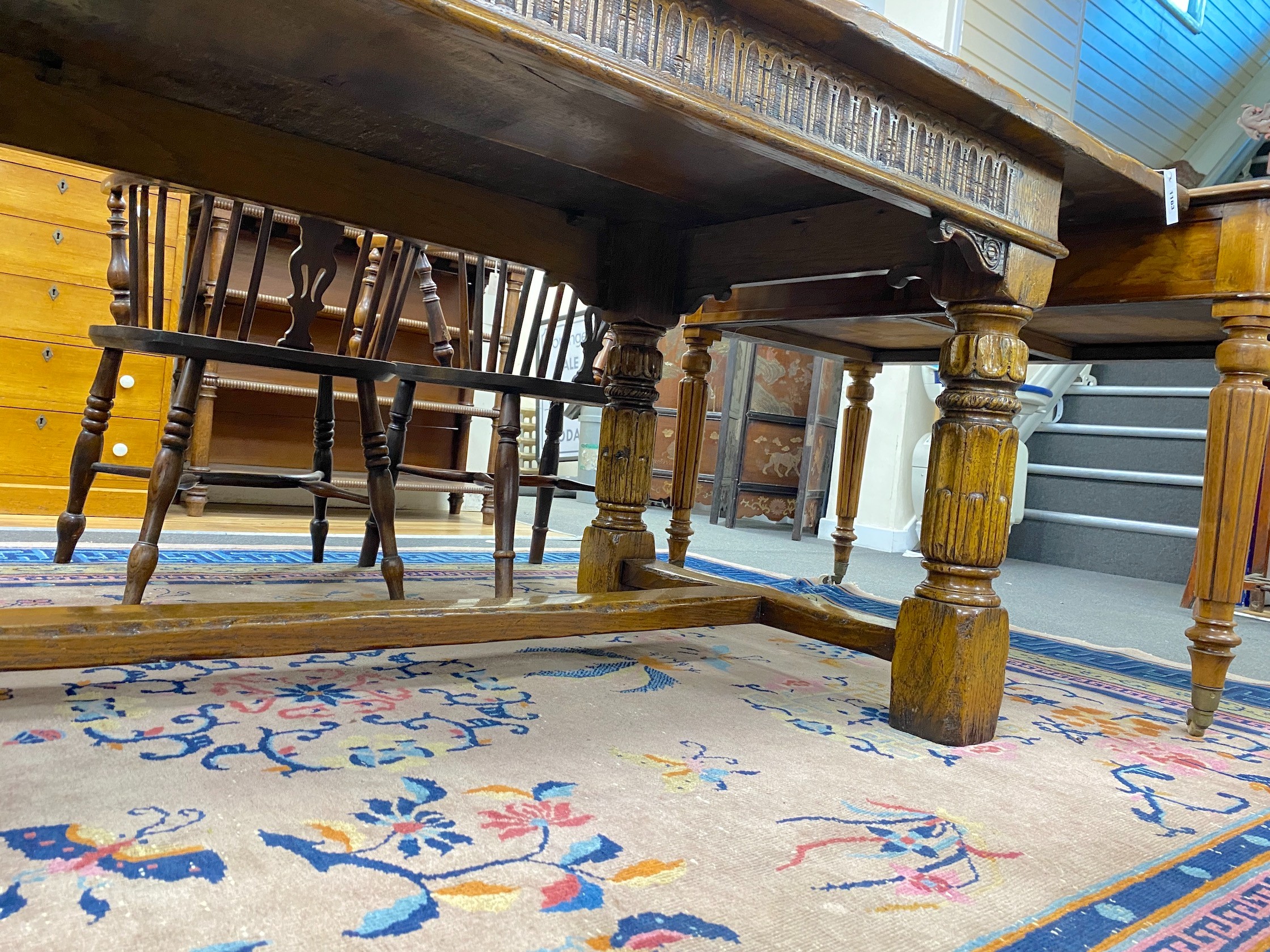 An 18th century style rectangular pale oak refectory dining table with central stretcher and two detachable extending leaves, (lacking three bolts) length 244cm, width 91cm, height 75cm, extending leaves each 46cm